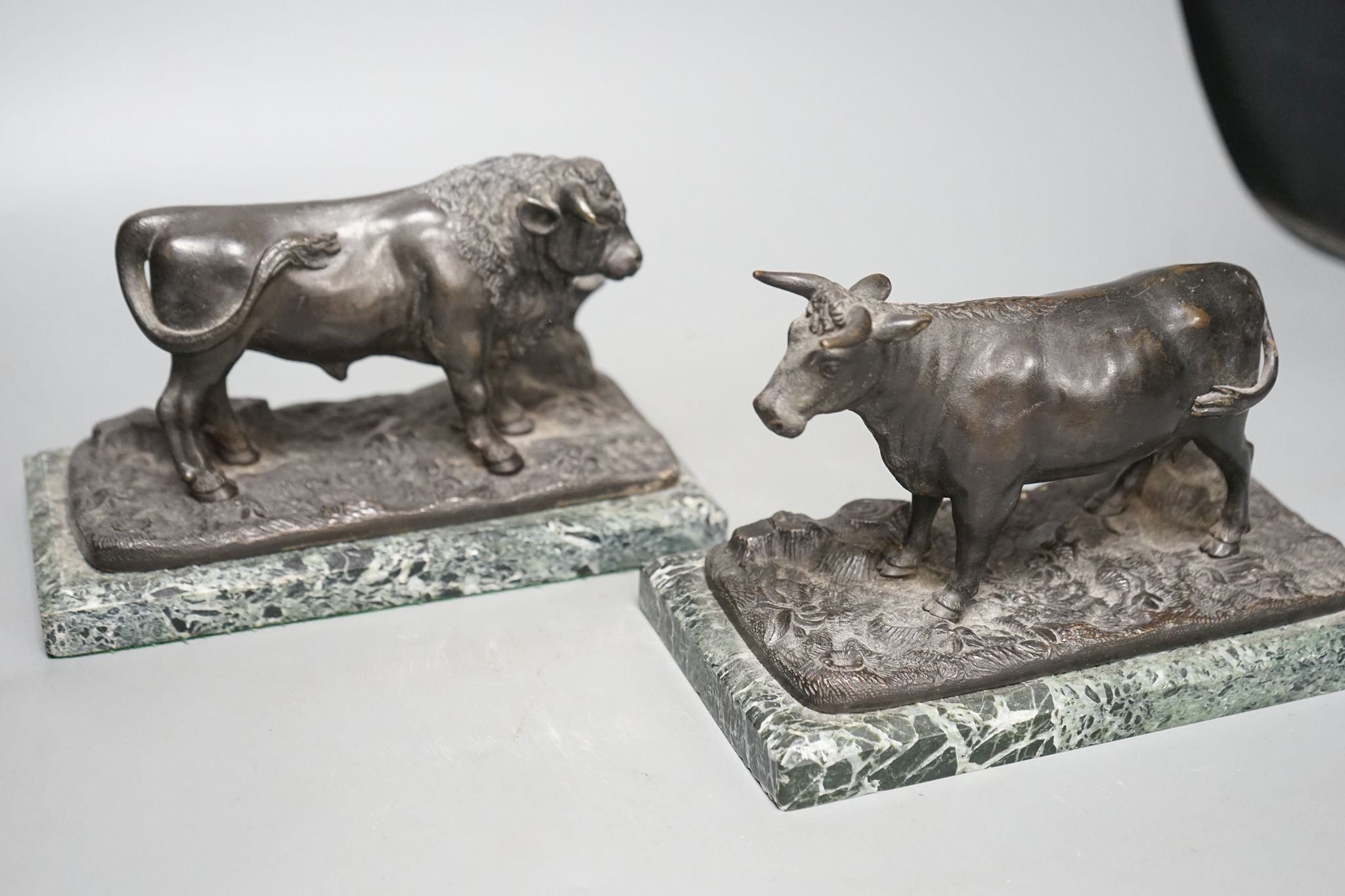 A pair of 20th century bronzes, a cow and a bull, on marble bases, 21cm